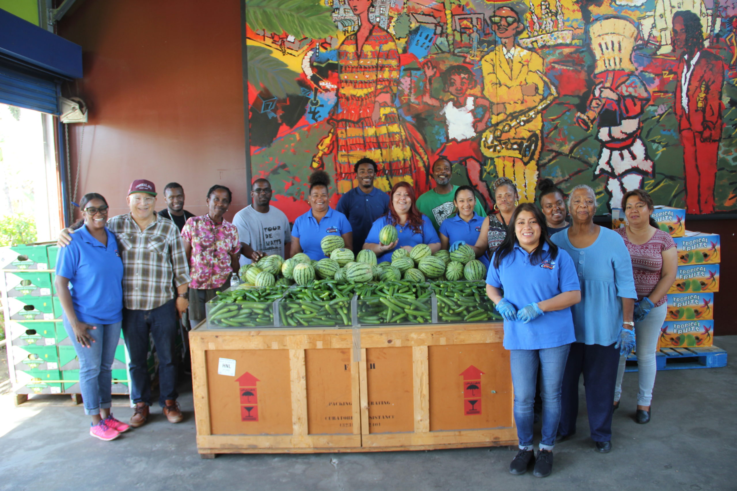 WLCAC team posing with fruit and art