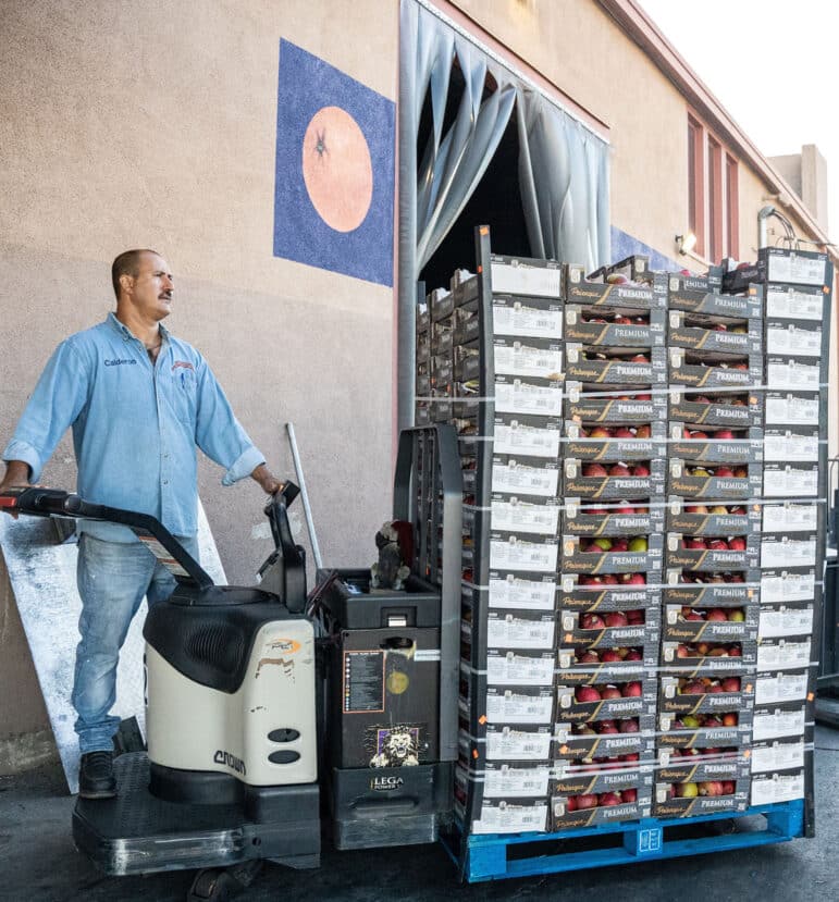 Man moving pallettes and crates