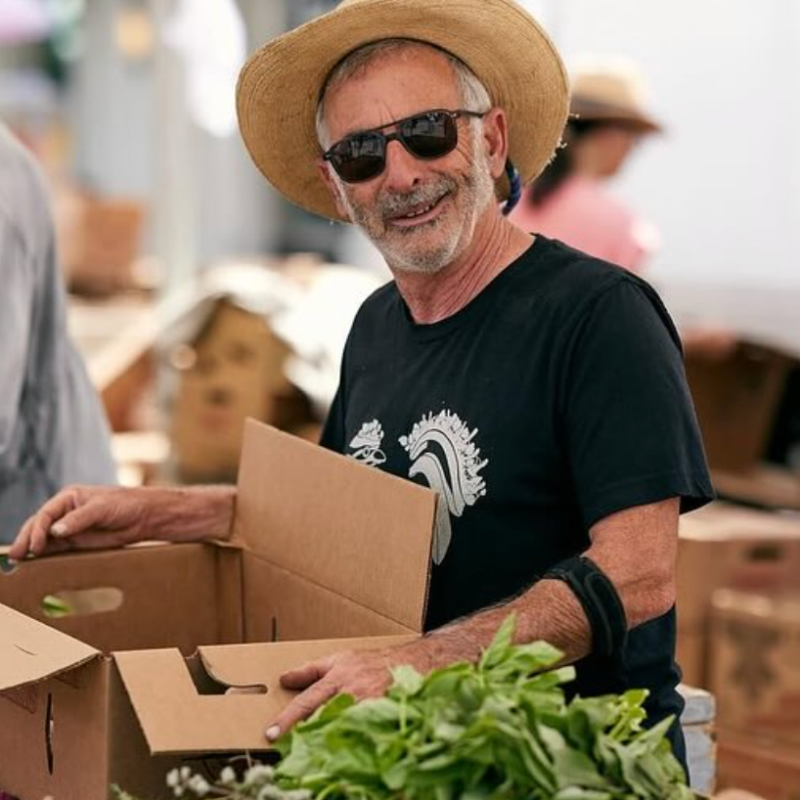 partners sorting leafy greens at farmers market recovery for food forward's food rescue in los angeles.
